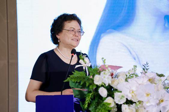 A person standing at a podium with a microphoneDescription automatically generated A person standing at a podium with a microphoneDescription automatically generated